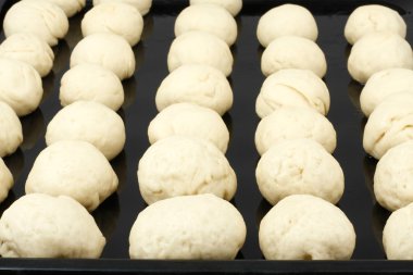 Harvesting of dough for buns clipart
