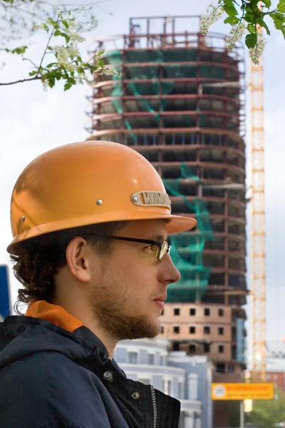 Stock image Builder look at the building