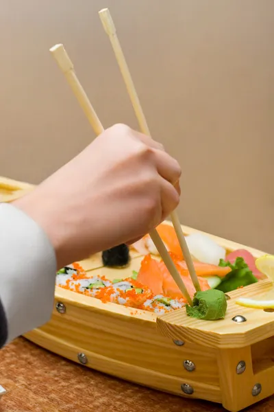 stock image Woman`s hand take little bit of wasabi