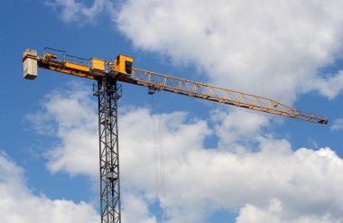 Lifting crane uder blue sky clipart