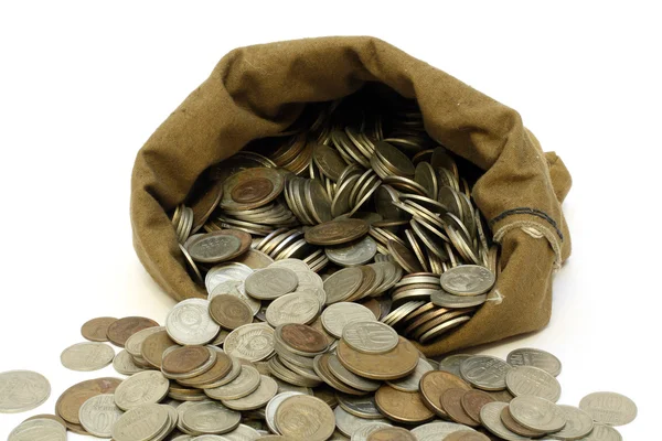 Peníze mince vylijte z vaku — Stock fotografie