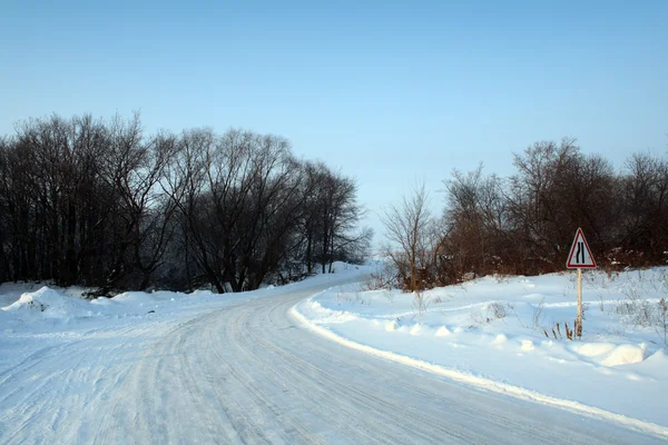 Winter road with sign — Stock Photo, Image