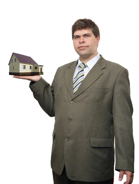 Homme d'affaires avec maison à la main — Photo