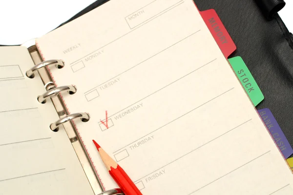 Open organizer and red pencil — Stock Photo, Image