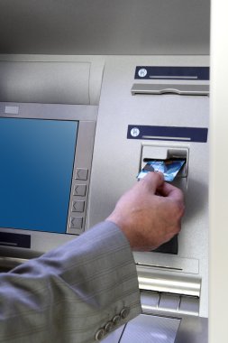 Hand inserting card into cash dispense clipart
