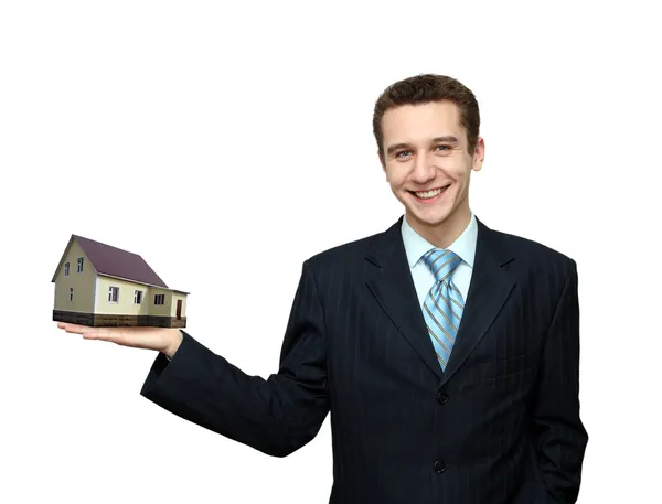 Zakenman met woonhuis in hand — Stockfoto