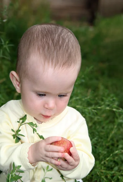 Small baby holding apple — Stok fotoğraf
