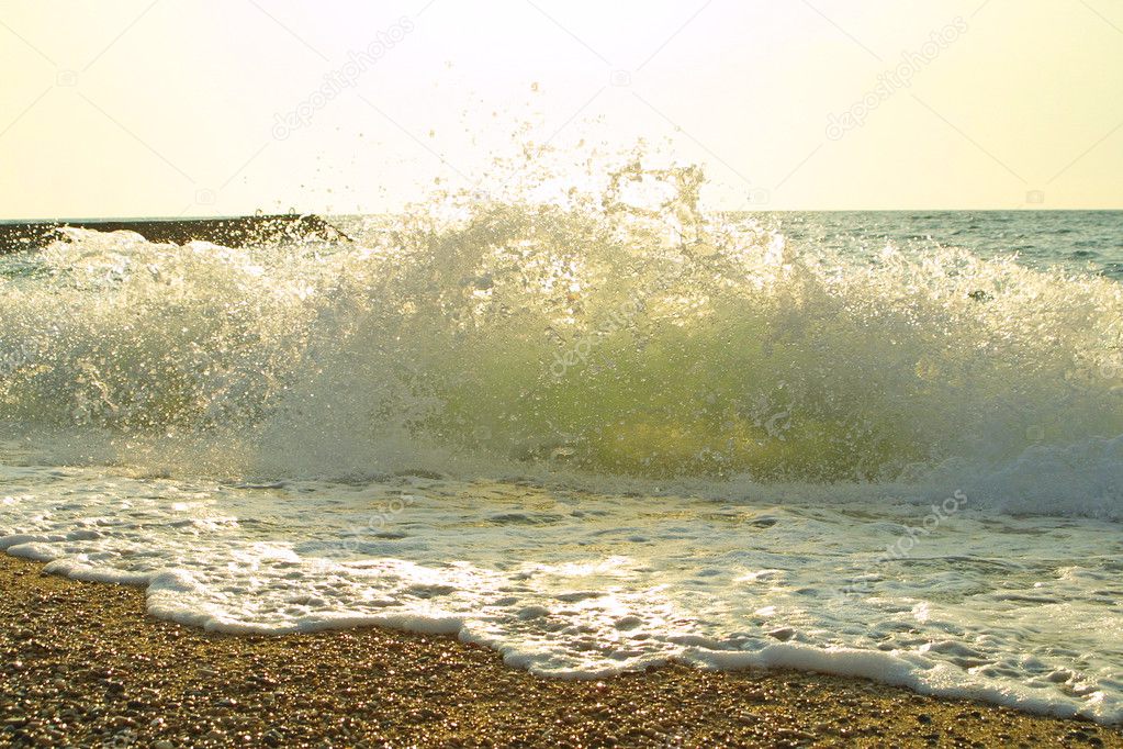 Sea beach with waves, splashes and foam