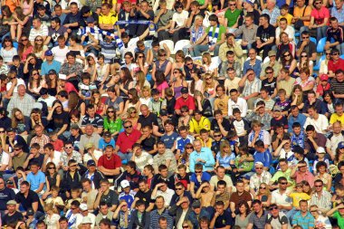 People seat on a stadium tribune