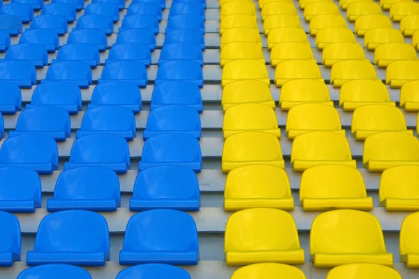 Blue and yellow empty stadium seats — Stock Photo, Image