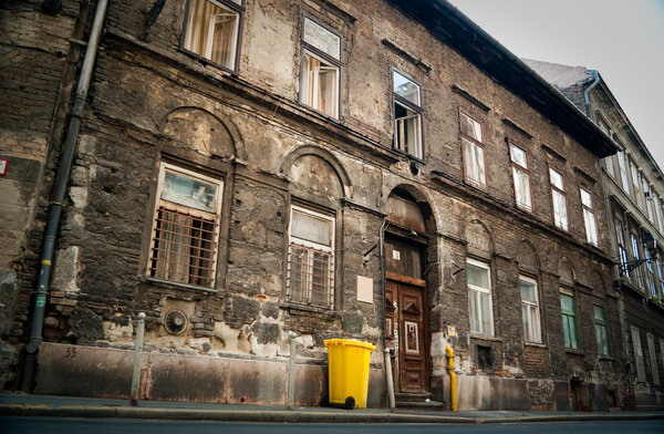 Ancient house and modern trash container in the Jewish district of Budapest, Hungary