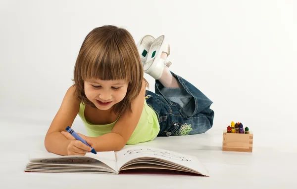 Cute little girl with drawing book — Stock Photo, Image
