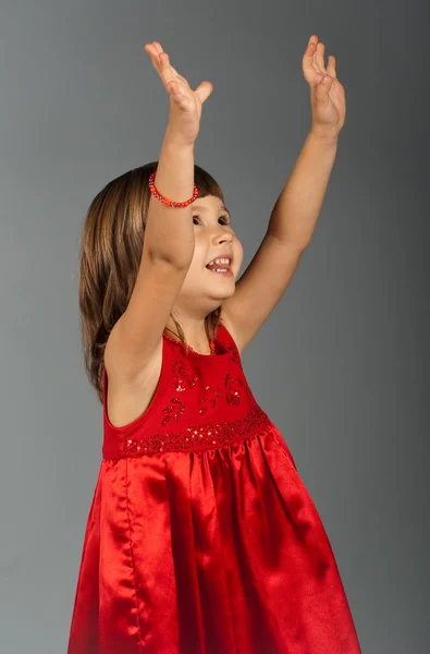 Cute little girl holding hands up — Stock Photo, Image