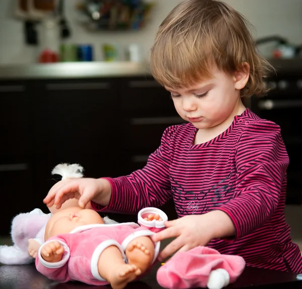 Little girl with a doll — Stock Photo, Image