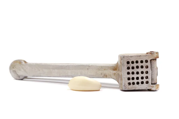 Garlic clove and crusher — Stock Photo, Image