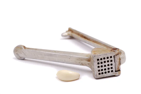 Garlic clove and crusher — Stock Photo, Image