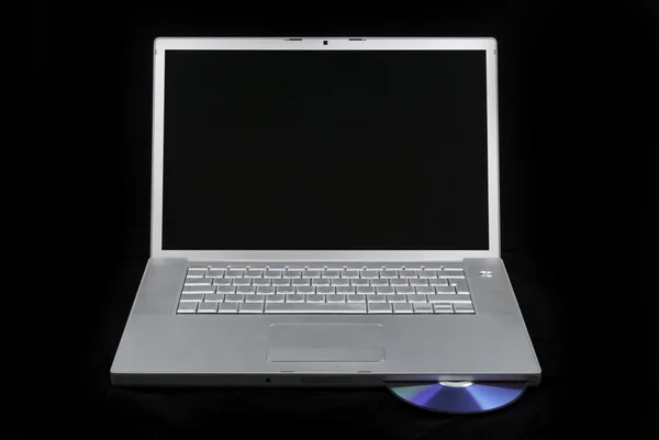 Laptop isolated with CD — Stock Photo, Image