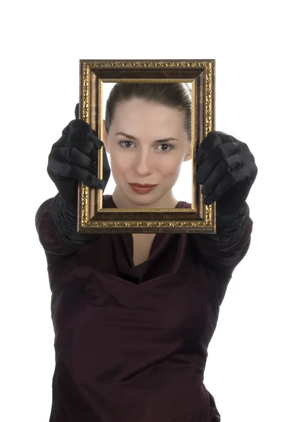 Mujer mirando a través de marco de imagen — Foto de Stock