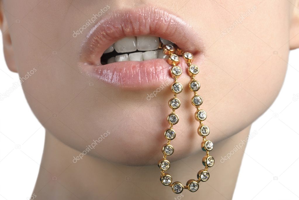 Woman holding bracelet in her mouth