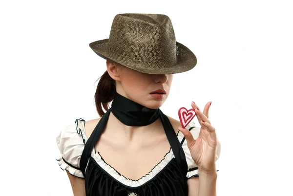 Woman wearing hat showing heart shaped c — Stock Photo, Image