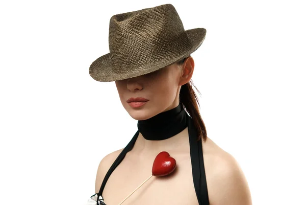 Woman wearing hat showing heart shaped c — Stock Photo, Image