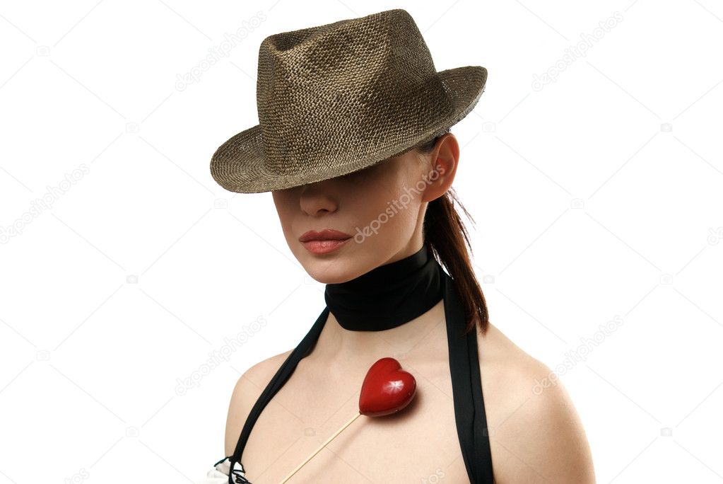 Woman wearing hat showing heart shaped c