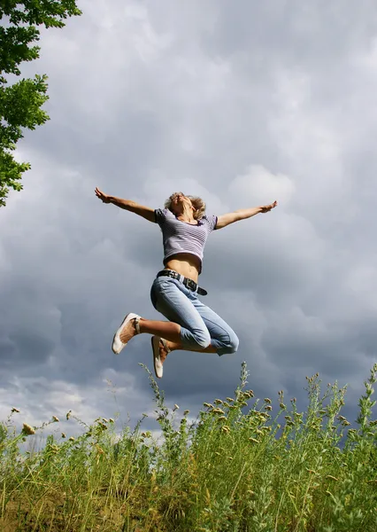 Happy young woman jumps — Stock Photo, Image