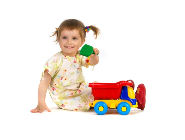 Досить маленька дівчинка і її іграшки — стокове фото