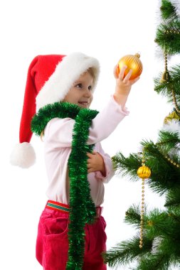 Cute girl near the christmas tree clipart