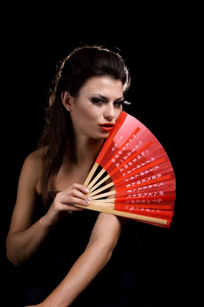 Szép nő, piros ventilátorral — Stock Fotó