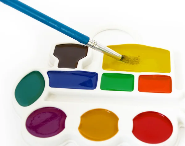 Box of watercolors and a brush — Stock Photo, Image