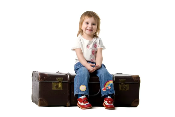 Cute baby sitting in a old suitcase — Stock Photo, Image