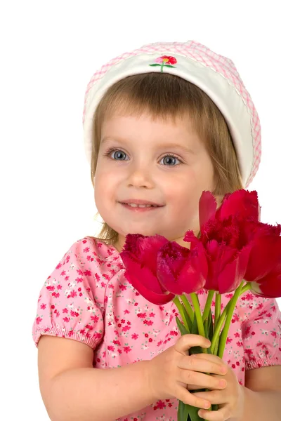 Schattig klein meisje geven tulpen — Stockfoto