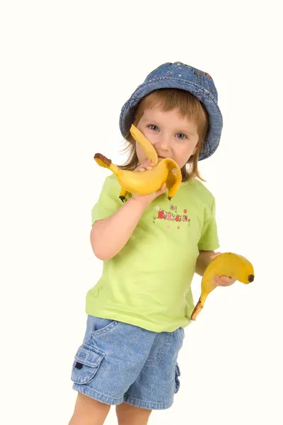 Holčička jí banány — Stock fotografie