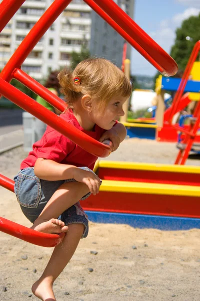 Little girl on playground equipment — Stock Photo, Image