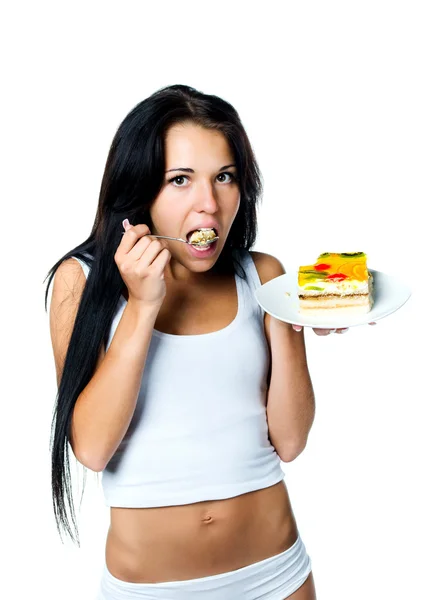 Aantrekkelijke vrouw eten een taart — Stockfoto