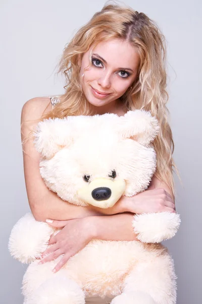 Beautiful girl with a teddy bear — Stock Photo, Image