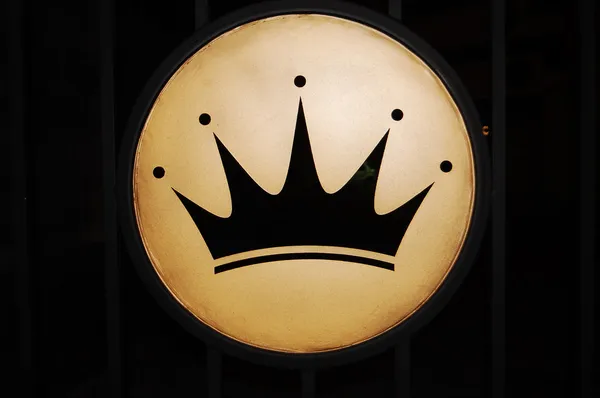 Black crown on a golden background