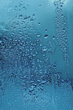 Water drops and frost on glass clipart