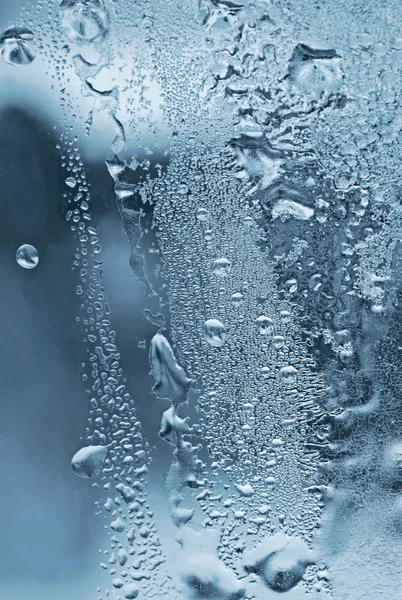 Wassertropfen und Frost auf Glas — Stockfoto