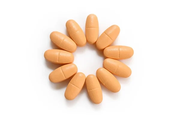 Orange pills over white — Stock Photo, Image