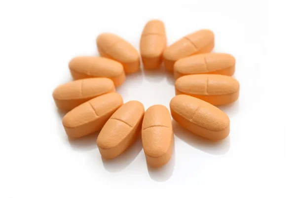 Orange pills over white — Stock Photo, Image
