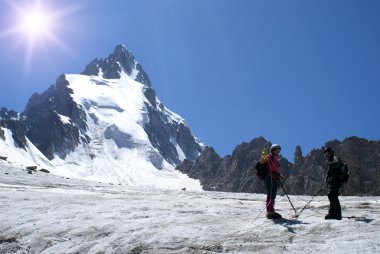 Two alpinists on a glacier clipart