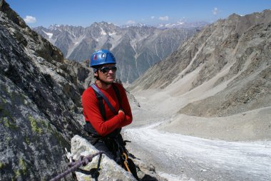 Mountaineer on background mountains clipart