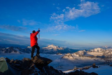 Mountaineer in red jacket clipart