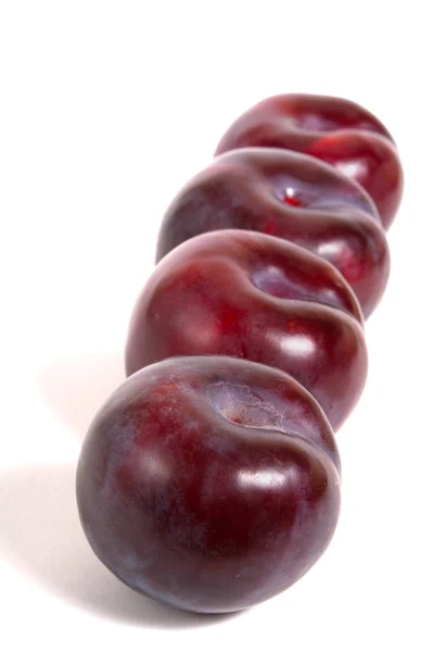 stock image Four ripe plums