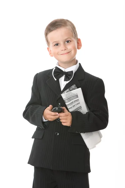 Niño sosteniendo un teléfono celular y periódico —  Fotos de Stock