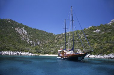 Yacht in a mediterranan bay clipart