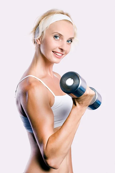 Girl with a dumb-bell — Stock Photo, Image