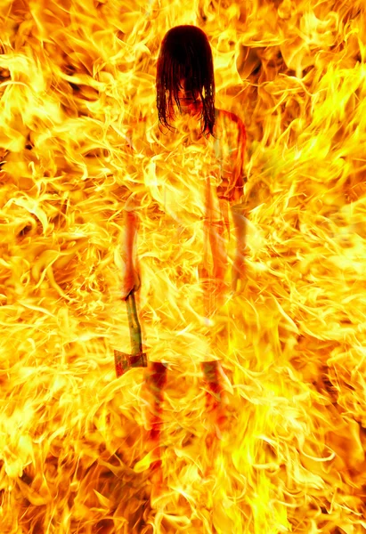 Girl with an axe in a fiery flame. on pa — Stock Photo, Image